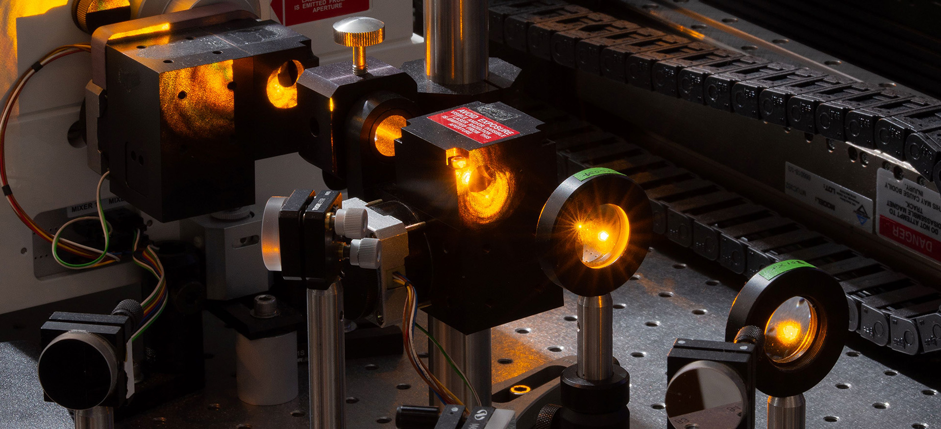 Image of an ultrafast laser laser system in the McCusker lab showing light pulsing through the laser line mirrors in the optical system of the device. The devices is used to develop a fundamental understanding of the interplay between the chemical structure and/or composition of a molecule and the mechanism by which that molecule redistributes energy it absorbs in the form of light.