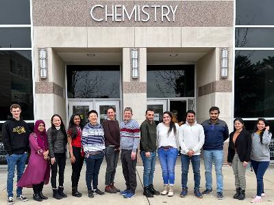 Members of the Warren Lab stand outside the chemistry building at MSU